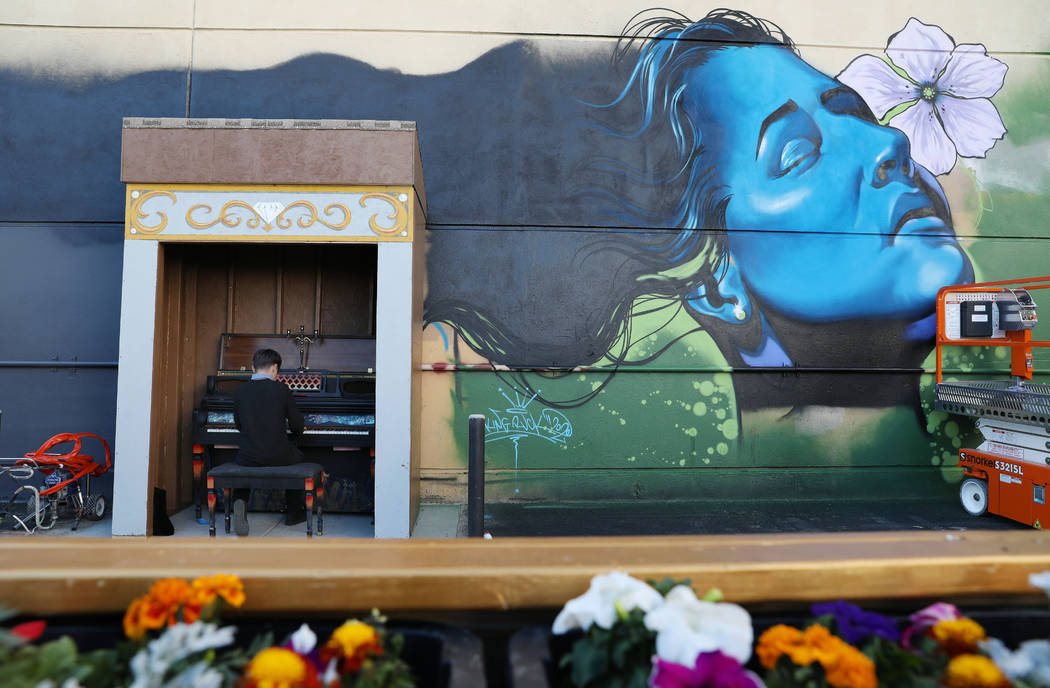 Jules Kessler, 14, plays a donated piano during the grand opening of dT-Alley in Las Vegas on ...