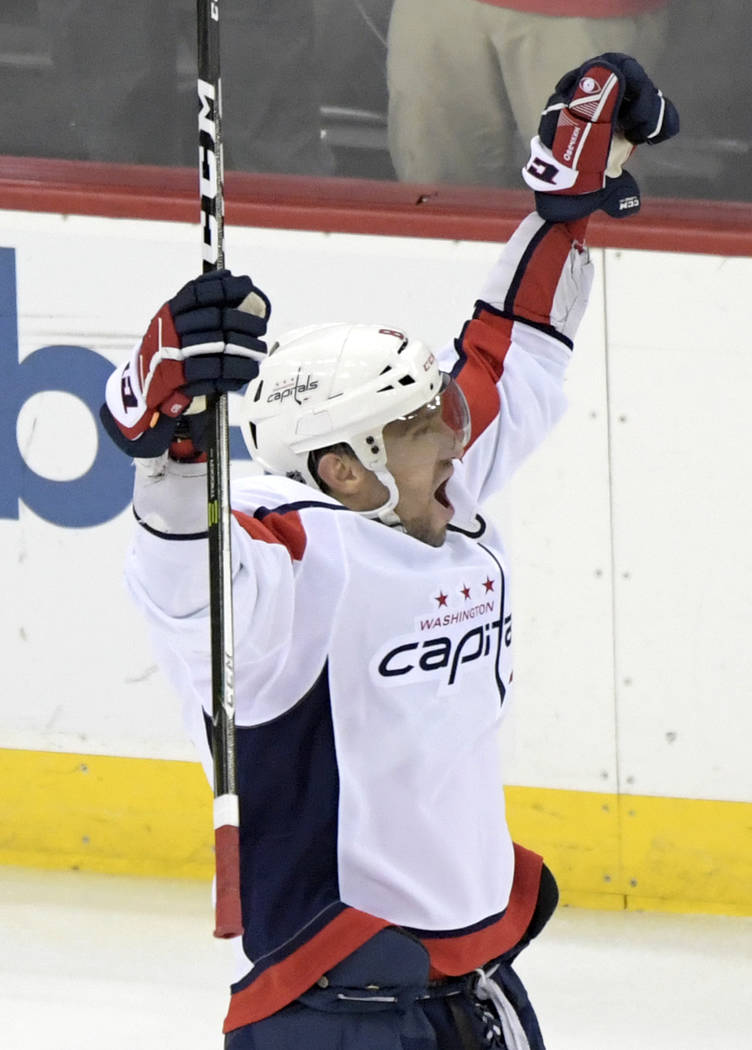 Washington Capitals left wing Alex Ovechkin (8) celebrates his 700th career goal during the thi ...