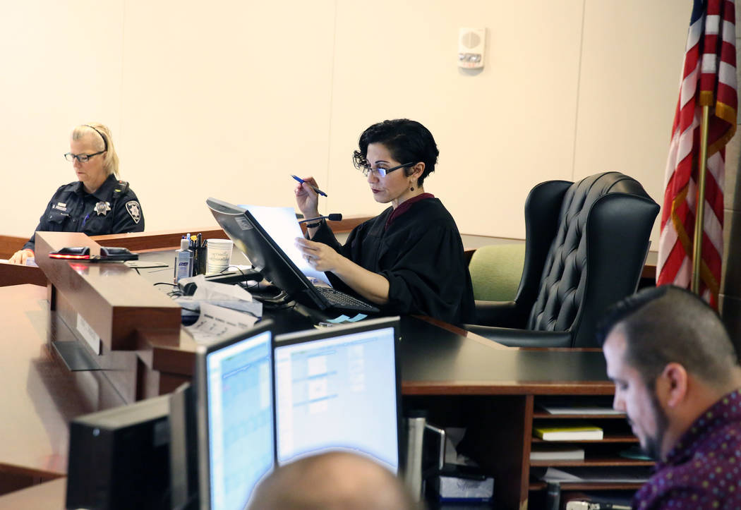 Judge Holly Stoberski, center, preside over the initial appearance of suspects at the Regional ...