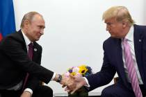 In this June 28, 2019, file photo, President Donald Trump, right, shakes hands with Russian Pre ...