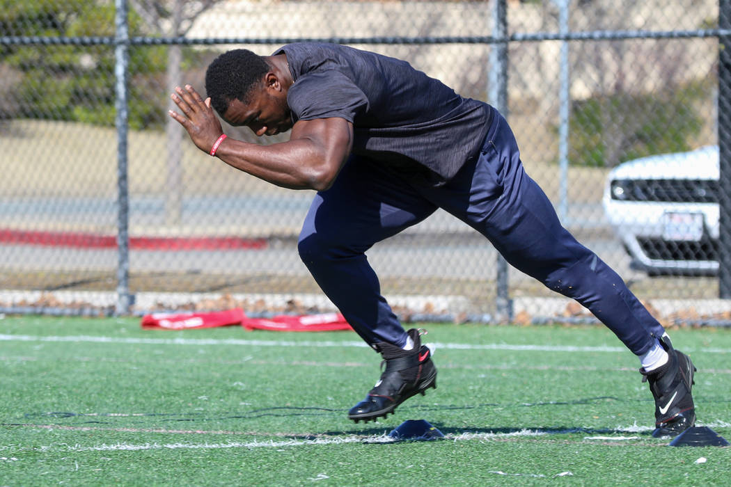 Former UCLA running back Joshua Kelley practices his starts for the 40-yard dash during a worko ...