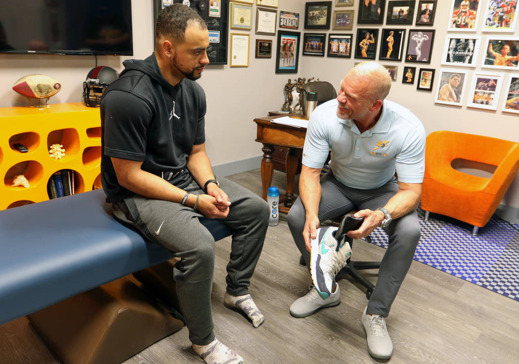 Sports Injury Specialist and Performance Coach Tobe Hanson, right, works with Stanford Universi ...