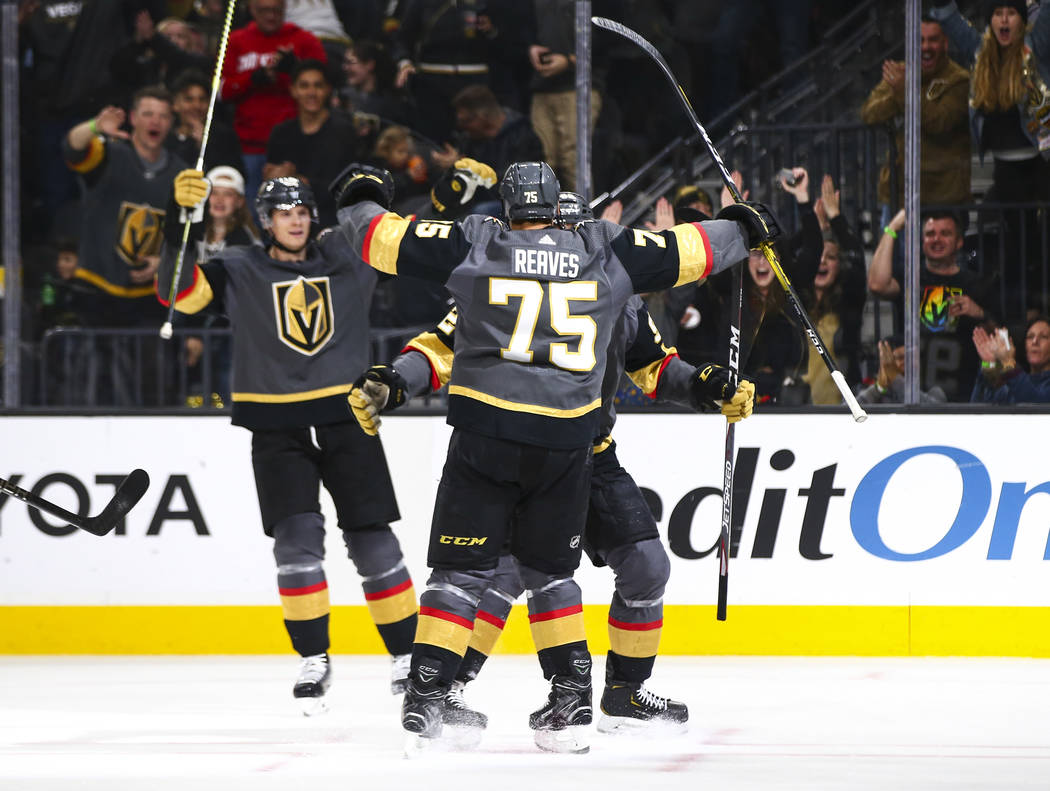 Golden Knights players celebrate a goal by Tomas Nosek during the first period of an NHL hockey ...