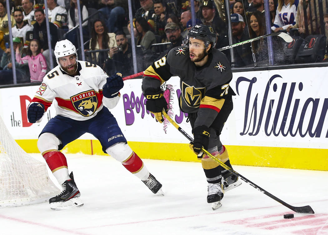 Golden Knights' Gage Quinney (72) sends the puck past Florida Panthers' Aaron Ekblad (5) during ...