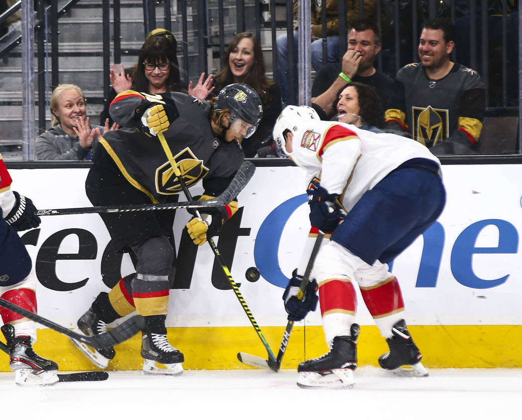 Golden Knights' William Karlsson (71) battles for the puck against Florida Panthers' Josh Brown ...