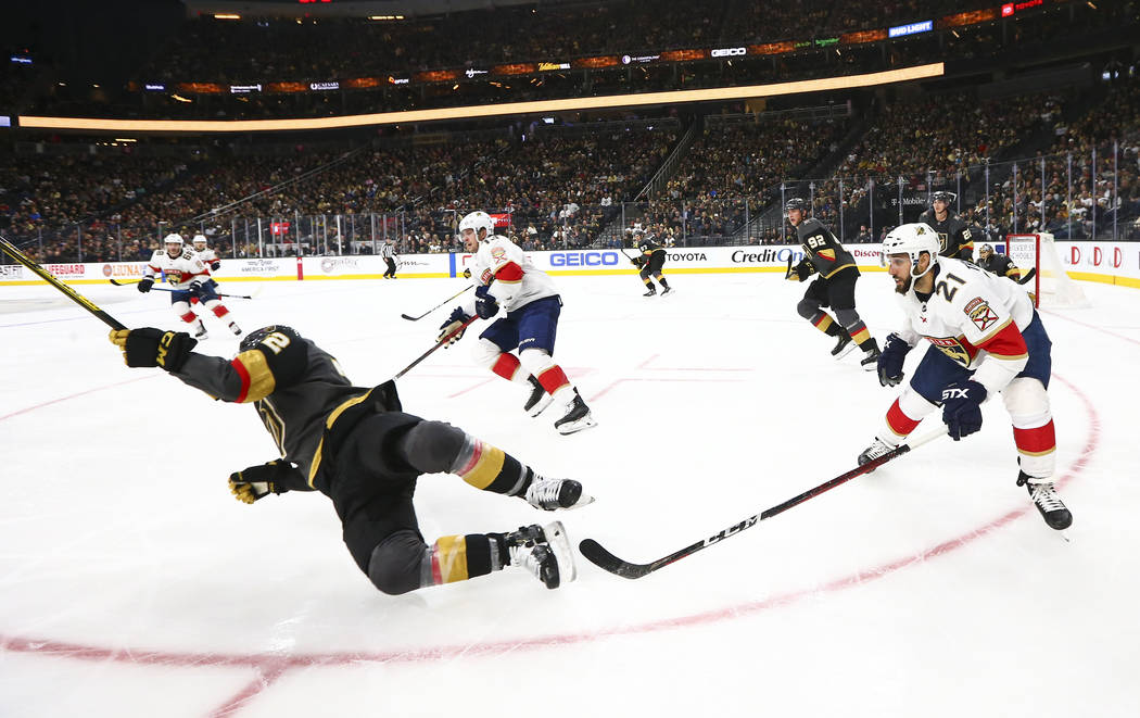 Golden Knights' Gage Quinney (72) gets tripped by Florida Panthers' Vincent Trocheck (21) durin ...