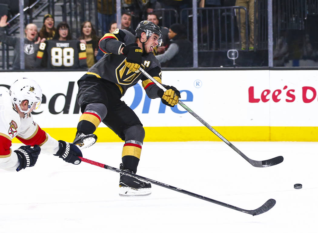 Golden Knights' Reilly Smith (19) shoots to score an empty net goal during the third period of ...