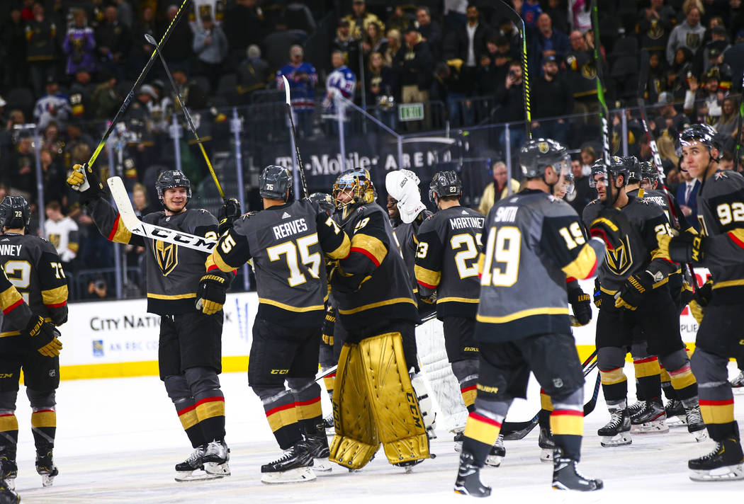 Golden Knights players celebrate after defeating the Florida Panthers in an NHL hockey game at ...