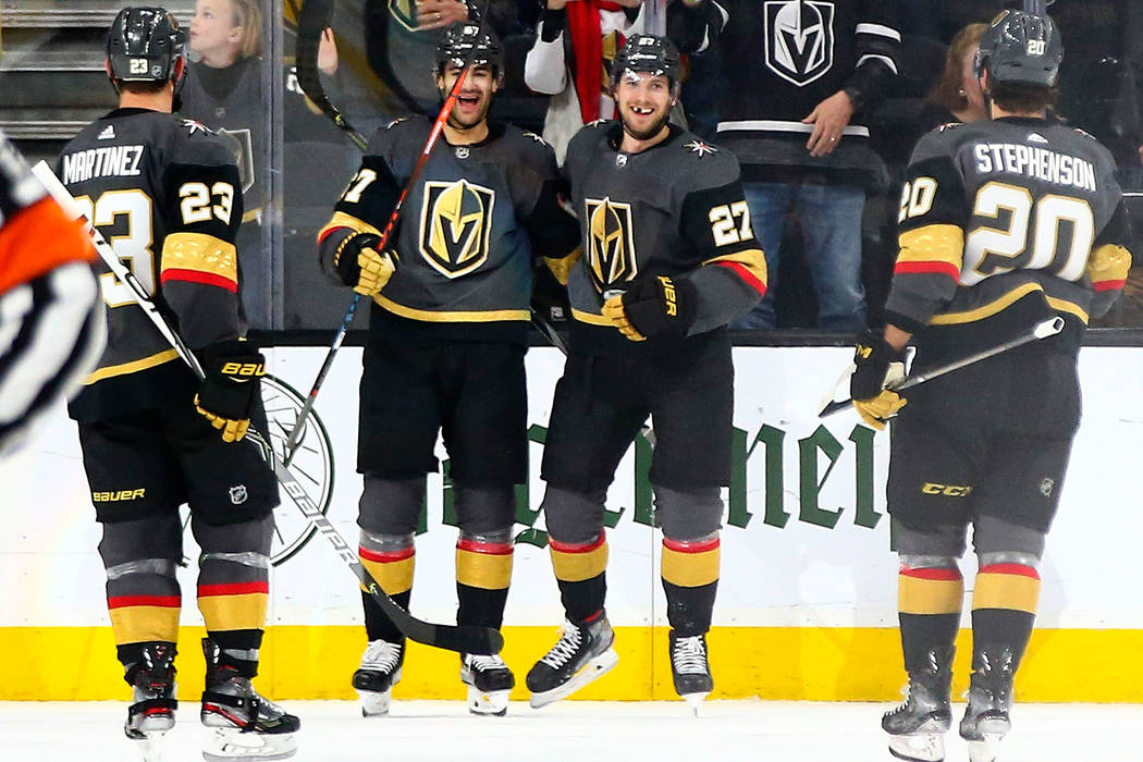 Golden Knights' Max Pacioretty, second from left, celebrates his goal with Shea Theodore (27) d ...