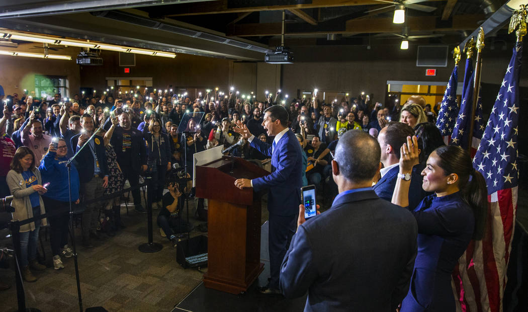Members of the crowd hold up their lit phones in support as Pete Buttigieg speaks at Springs Pr ...