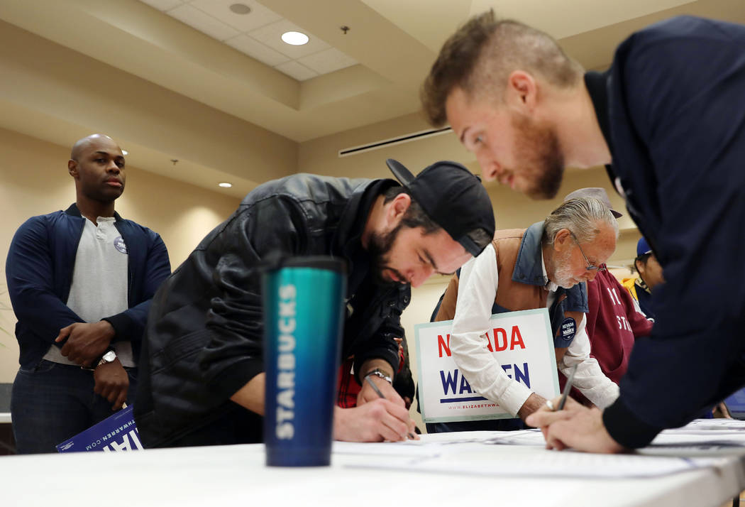 Caucus participants register before the caucus at the East Las Vegas Community Center in Las Ve ...