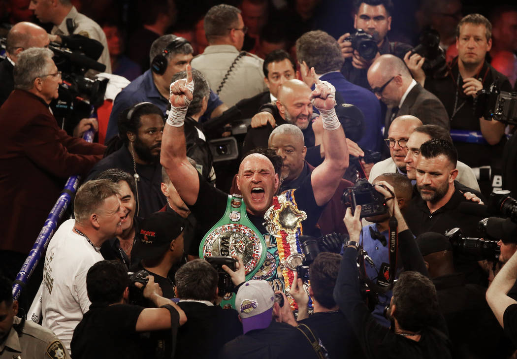 Tyson Fury celebrates after beating Deontay Wilder in the seventh round during their WBC heavyw ...