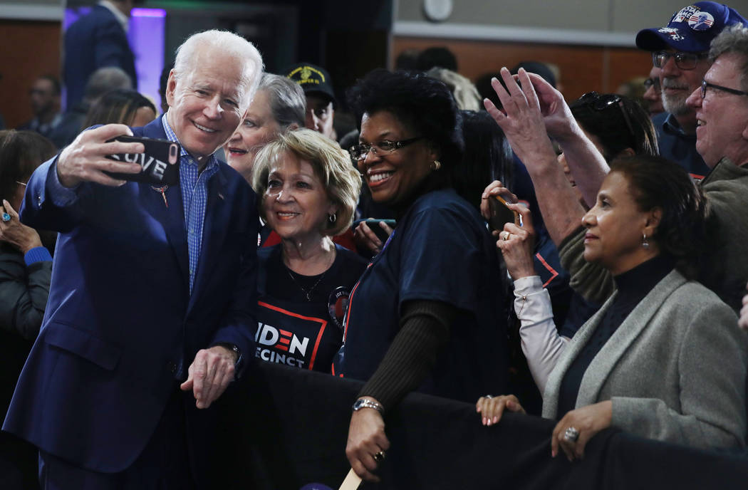 Democratic presidential candidate former Vice President Joe Biden takes photographs with suppor ...