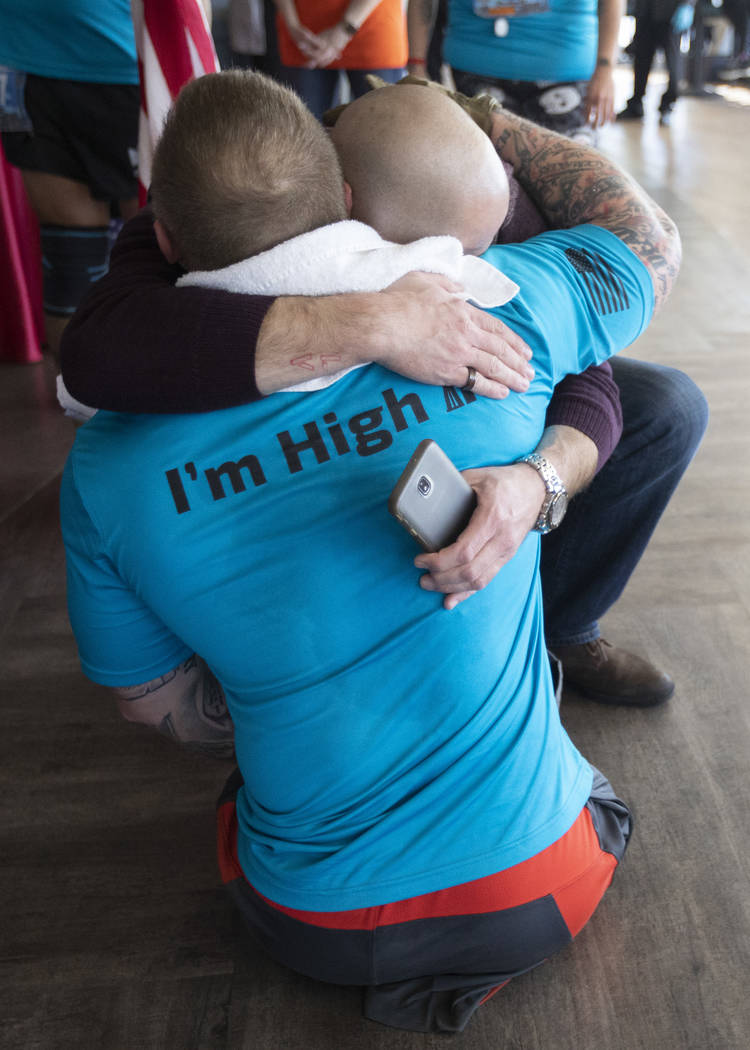 Travis Strong hugs his brother after climbing all 1,455 stairs at the Strat to support the Amer ...