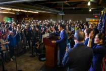 Members of the crowd hold up their lit phones in support as Democratic presidential candidate a ...