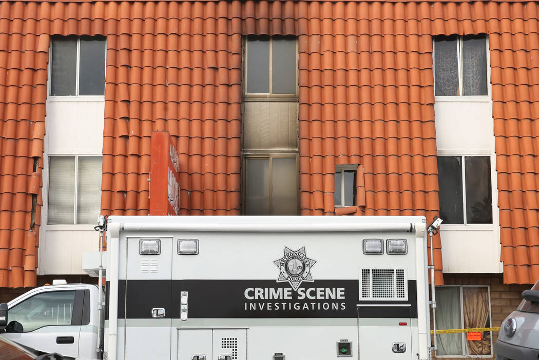 A Las Vegas Police Department crime scene truck is parked outside the Alpine Motel Apartments o ...