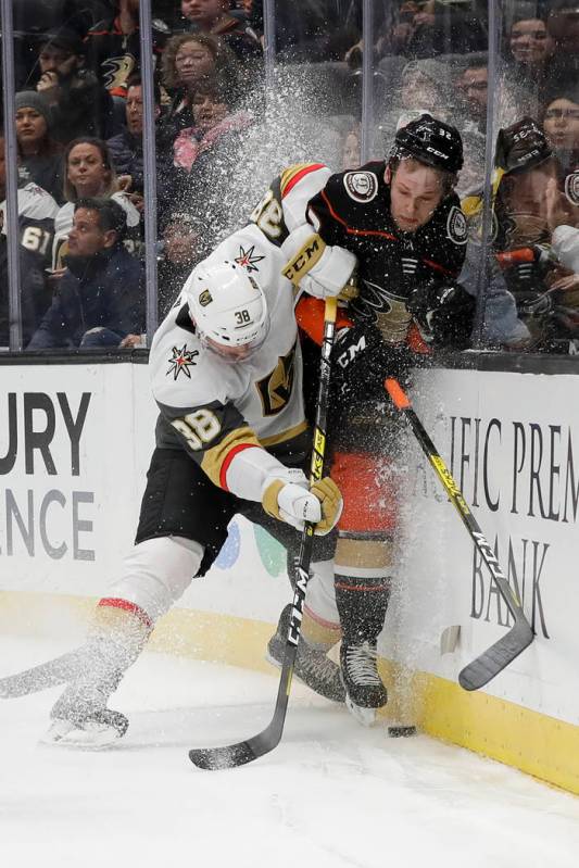 Vegas Golden Knights center Patrick Brown, left, checks Anaheim Ducks defenseman Jacob Larsson ...