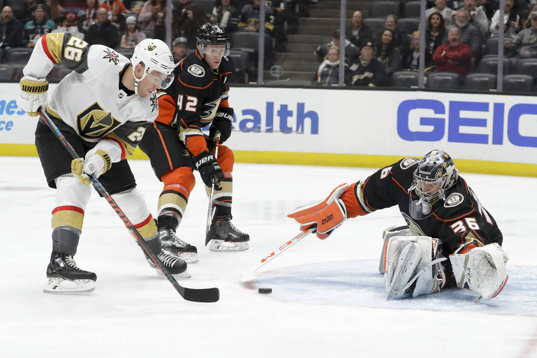 Anaheim Ducks goaltender John Gibson, right, blocks a shot by Vegas Golden Knights center Paul ...