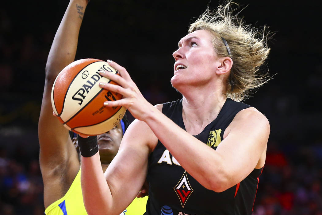 Las Vegas Aces' Carolyn Swords goes to the basket against Dallas Wings' Kaela Davis during the ...