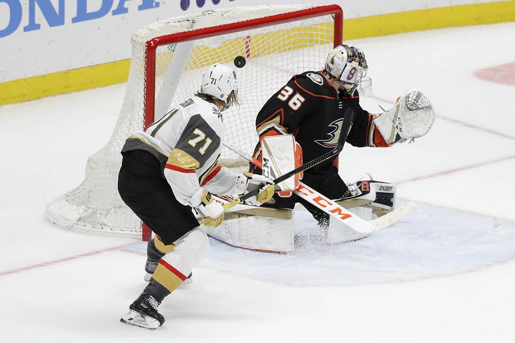 Vegas Golden Knights center William Karlsson, left, scores past Anaheim Ducks goaltender John G ...