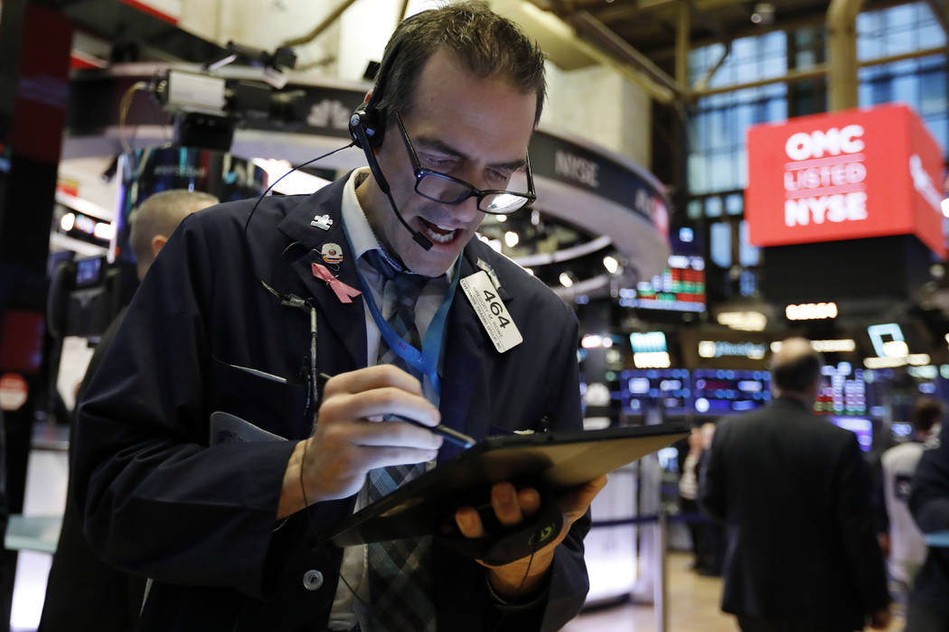 Trader Gregory Rowe works on the floor of the New York Stock Exchange, Monday, Feb. 24, 2020. S ...