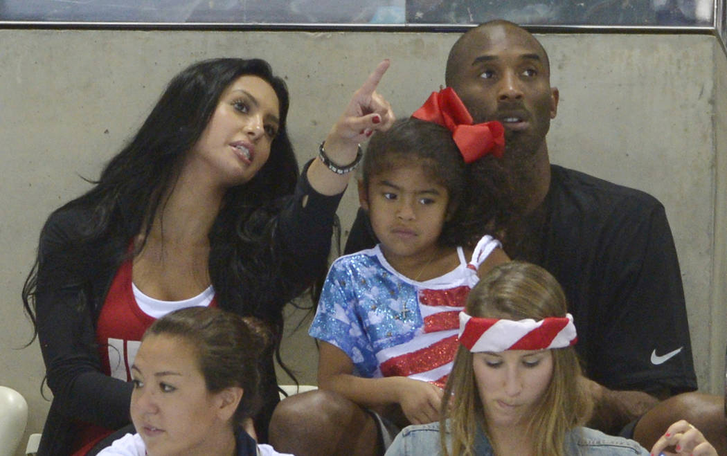 Kobe Bryant with his wife, Vanessa, and daughter Gianna prepare to watch the final night of swi ...