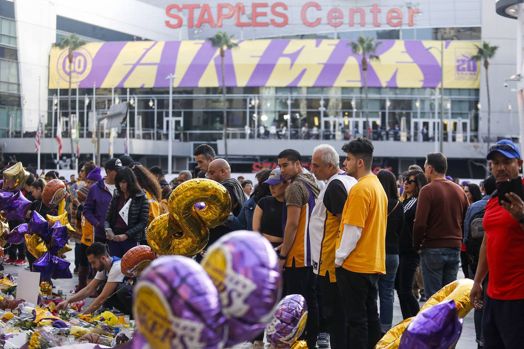 Fans gather to pay their respects at a memorial for Kobe Bryant in front of Staples Center, pri ...