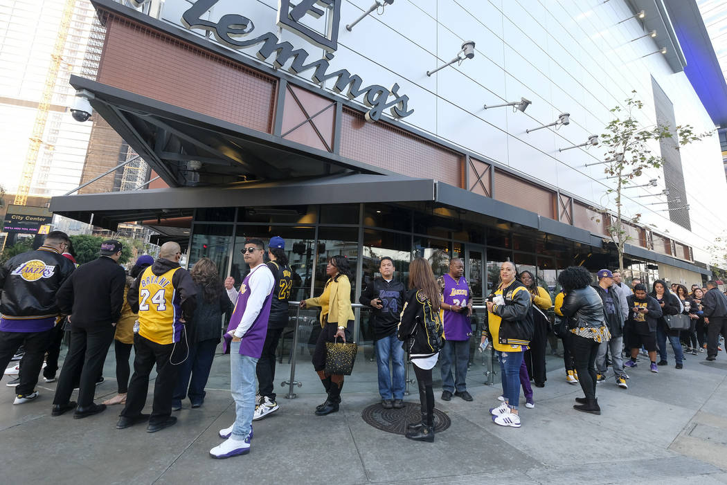 Fans line up to get into the Staples Center to attend a public memorial for former Los Angeles ...