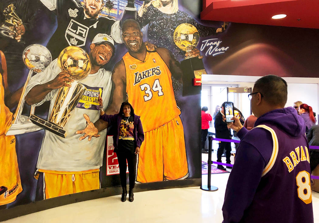 Janel Alexander, 55, of Encino, poses next to a mural that features Kobe Bryant and Shaquille O ...