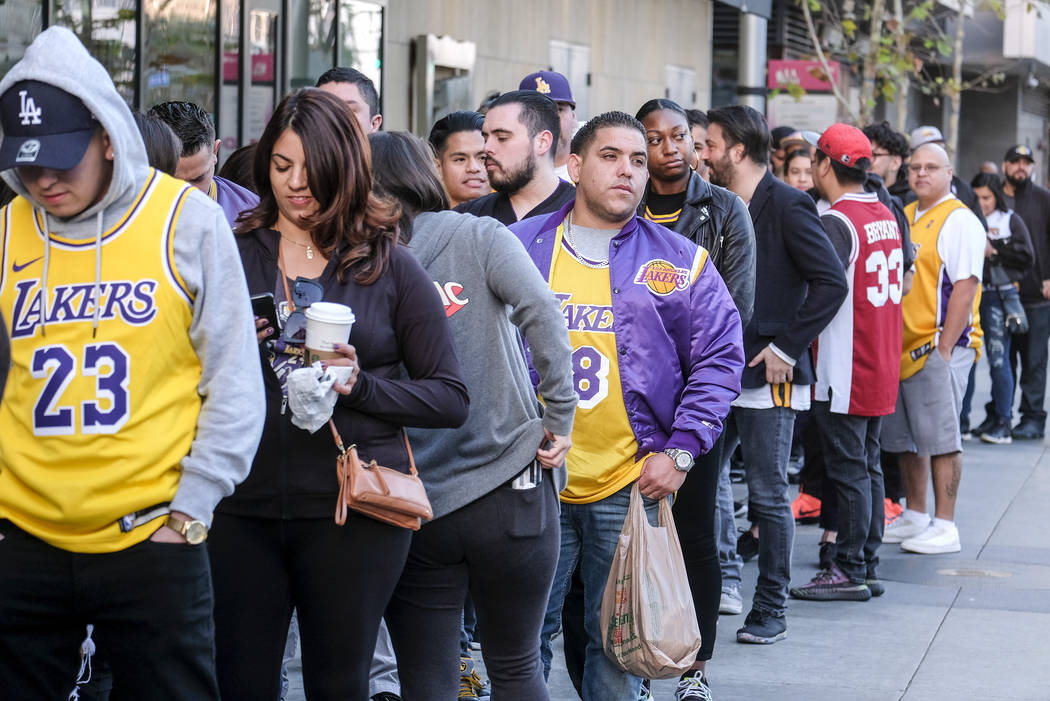 Fans line up to get into the Staples Center to attend a public memorial for former Los Angeles ...