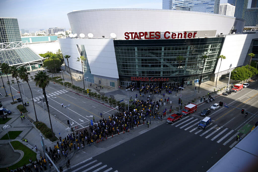 Fans line up to enter the Staples Center before a public memorial for former Los Angeles Lakers ...