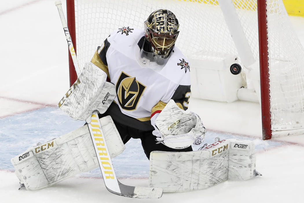 Vegas Golden Knights goaltender Malcolm Subban (30) makes a save as the puck deflects off him d ...