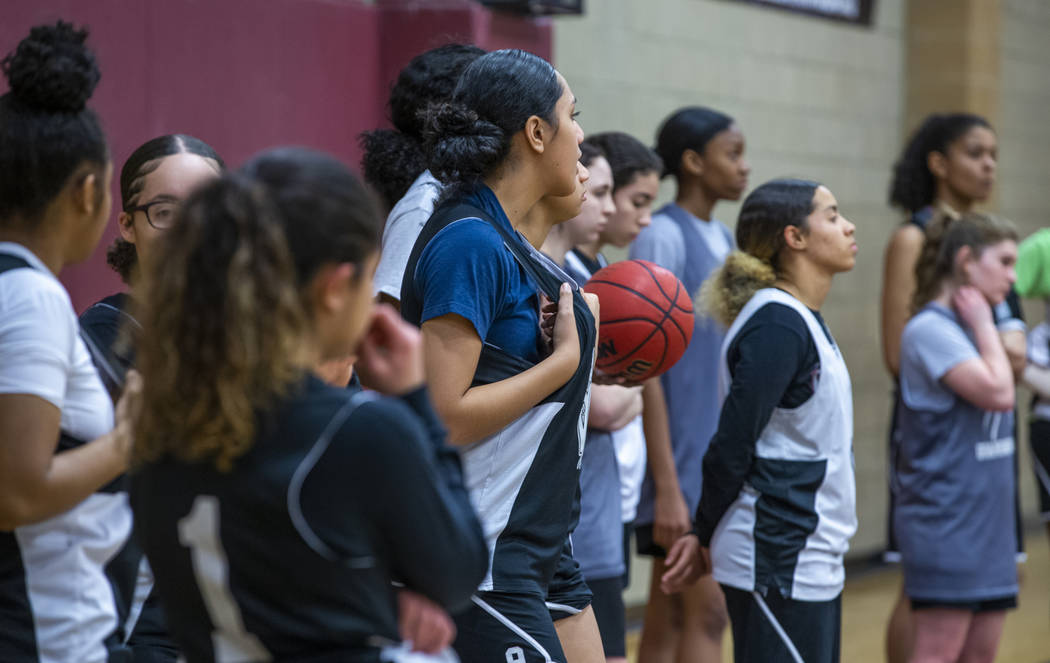 Desert Oasis girl's basketball team players stand on the base line and listen to instructions b ...