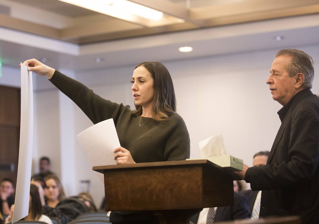 Allie Rossie, sister of A.J. Rossi, holds up a giant photo of A.J. while asking the suspect to ...