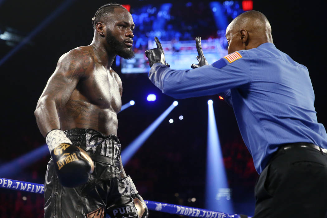 Deontay Wilder gets a count after getting knocked down by Tyson Fury in round 3 of the WBC worl ...