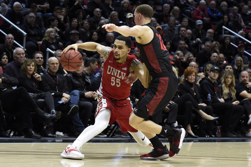 UNLV guard Elijah Mitrou-Long (55) plays San Diego State guard Malachi Flynn (22) during the se ...