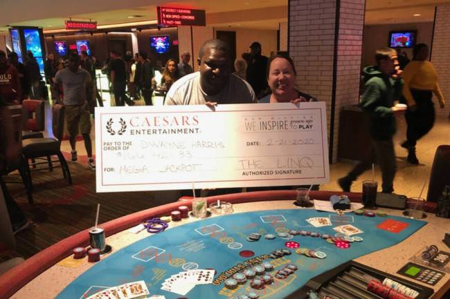 Dwayne Harris of Georgia celebrates winning $166,421 on a Three Card Poker mega jackpot Friday, ...