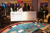 Dwayne Harris of Georgia celebrates winning $166,421 on a Three Card Poker mega jackpot Friday, ...