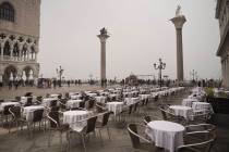 Empty tables sit in St. Mark's square in Venice, Italy, Tuesday, Feb. 25, 2020. Italy has been ...