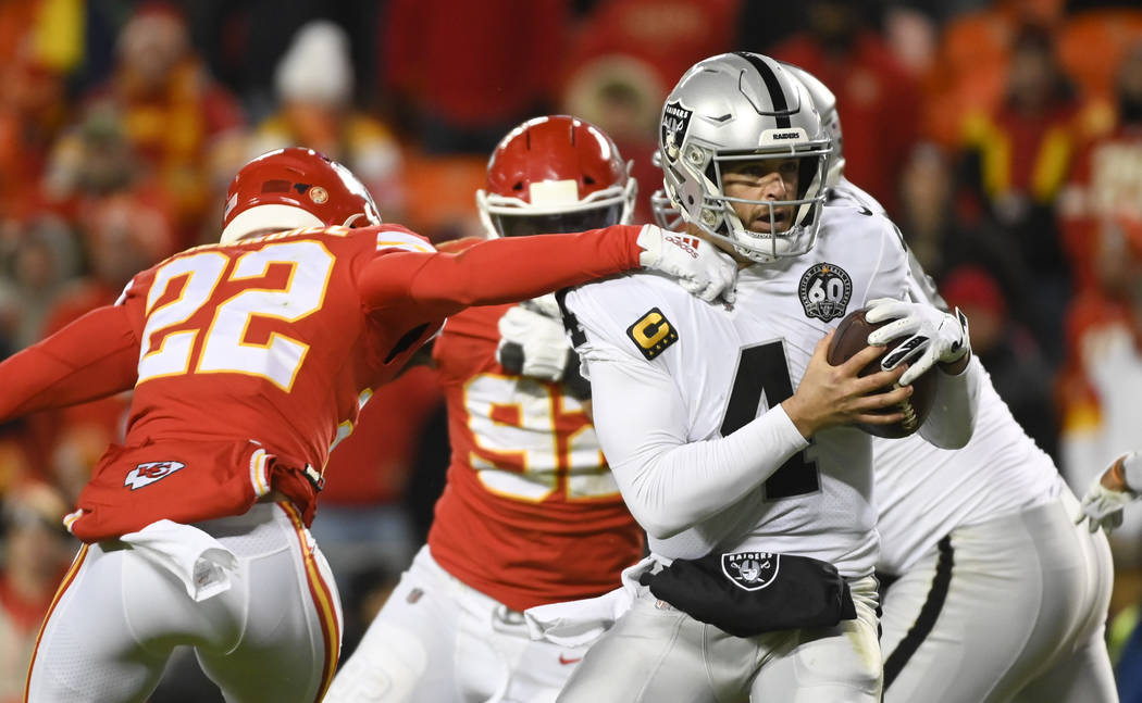 Oakland Raiders quarterback Derek Carr (4) is pressured by Juan Thornhill during the second hal ...