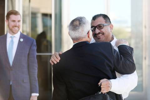 Attorney Shawn Perez, hugs defendant Pastor Palafox outside the Lloyd D. George U.S. Courthouse ...