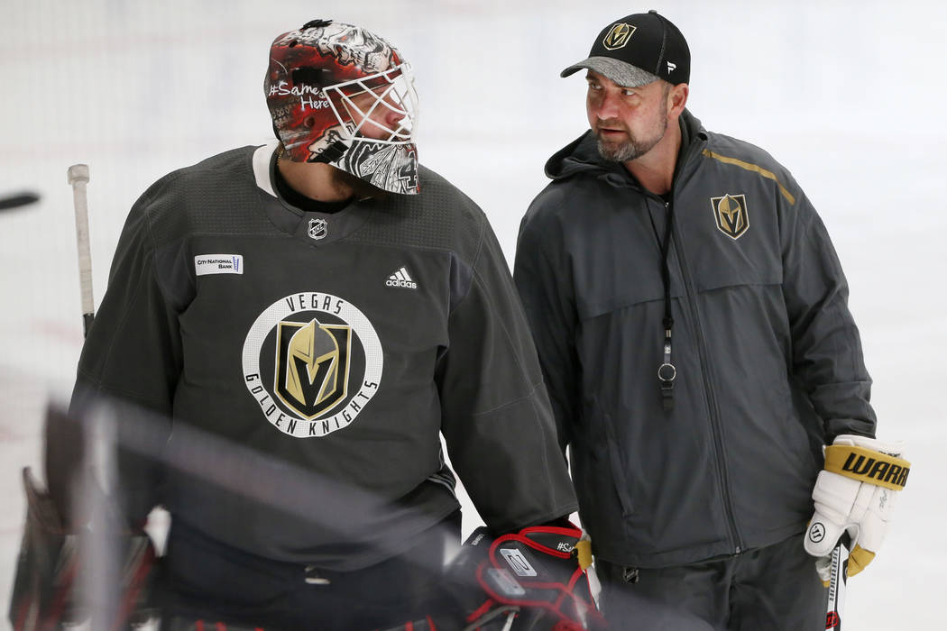 Vegas Golden Knights coach Peter DeBoer, right, talks to new team goaltender Robin Lehner durin ...