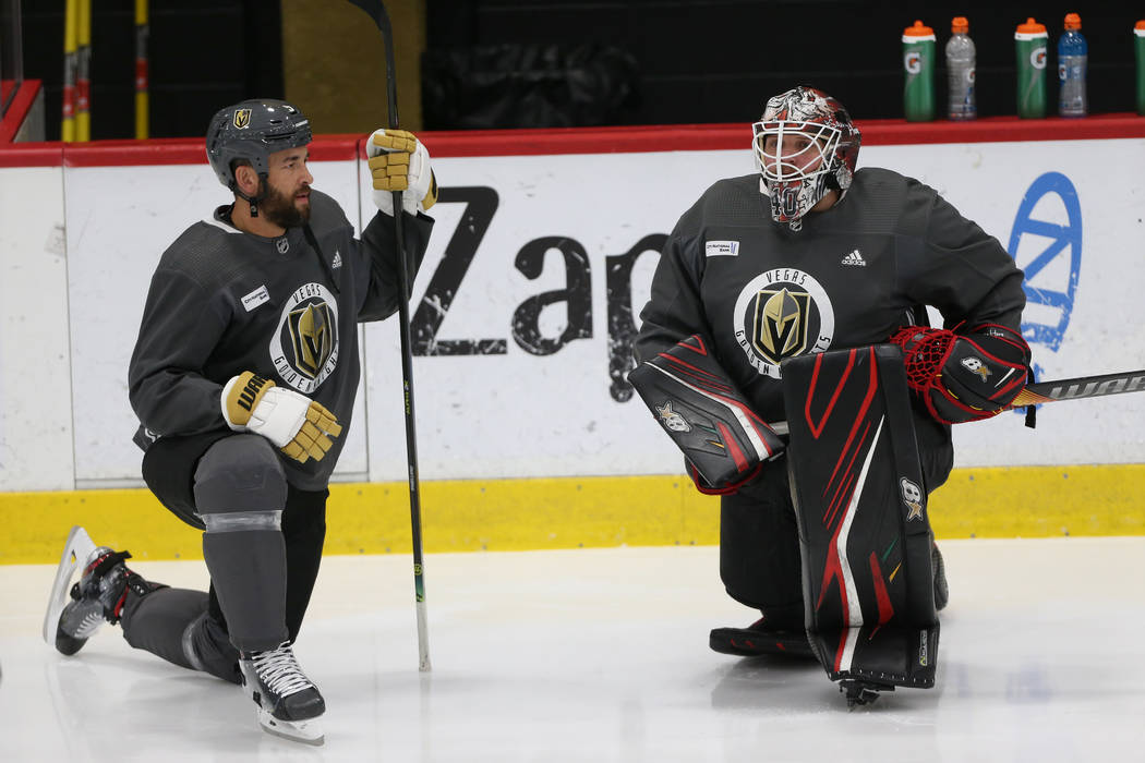 Vegas Golden Knights players Deryk Engelland, left, speaks to new team goaltender Robin Lehner ...