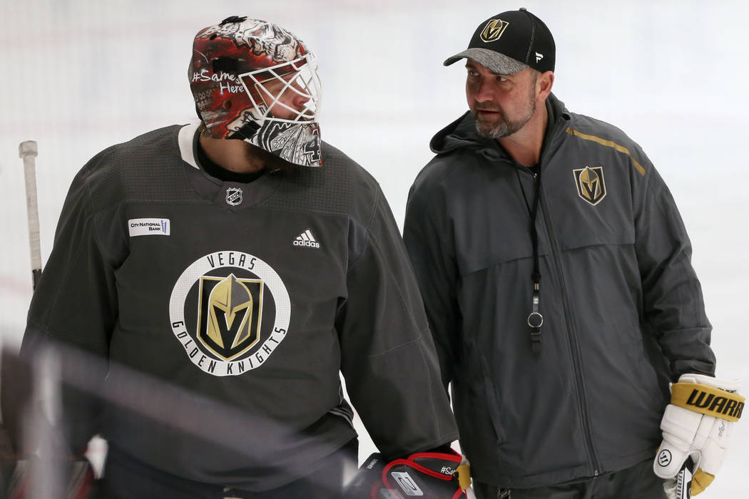 Vegas Golden Knights coach Peter DeBoer, right, talks to new team goaltender Robin Lehner durin ...