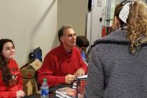 Danny Tarkanian signs copies of his book, "Rebel with a Cause," in the concourse of the Thomas ...