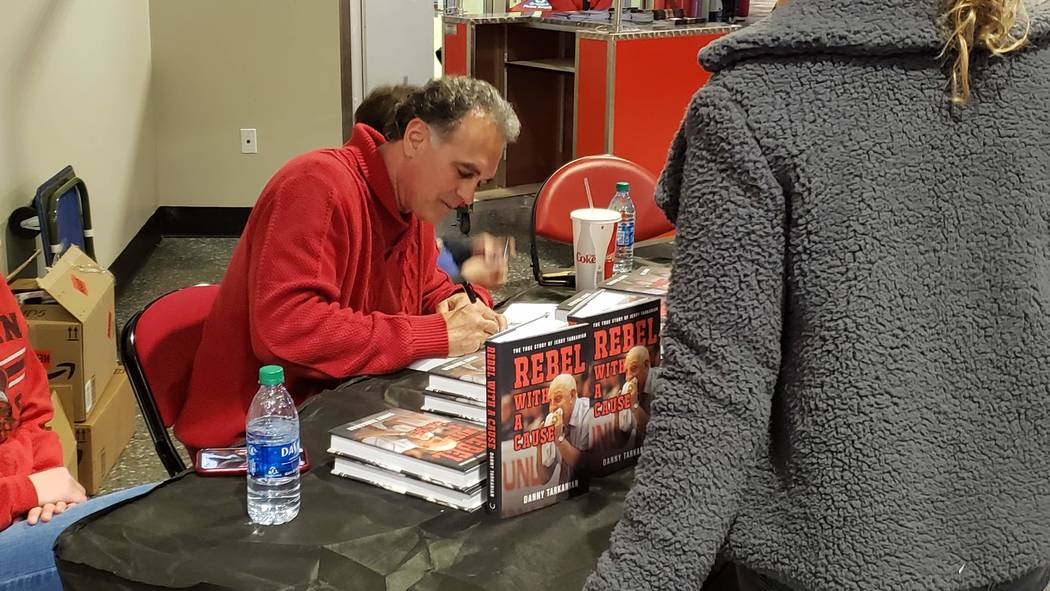 Danny Tarkanian signs copies of his book, "Rebel with a Cause," in the concourse of the Thomas ...