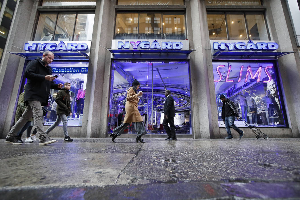Pedestrians pass the storefront of Peter Nygard's Times Square headquarters, Tuesday, Feb. 25, ...