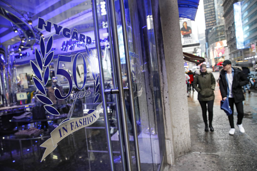 Pedestrians pass the storefront of Peter Nygard's Times Square headquarters, Tuesday, Feb. 25, ...
