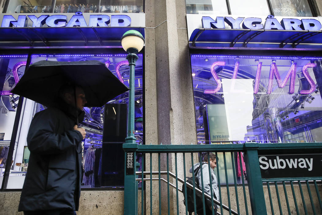 Pedestrians pass the storefront of Peter Nygard's Times Square headquarters, Tuesday, Feb. 25, ...