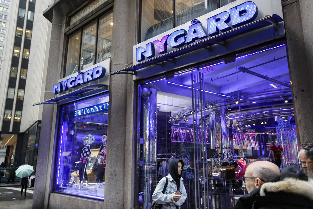 Pedestrians pass the storefront of Peter Nygard's Times Square headquarters, Tuesday, Feb. 25, ...